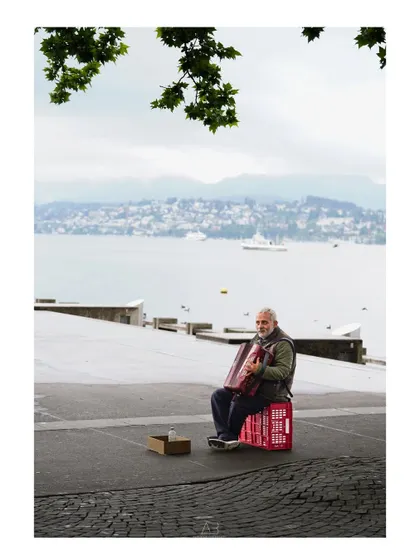 A street portrait of a musician playing his accordion by the lake. It’s a portrait earned by observing and waiting for the right, honest moment.