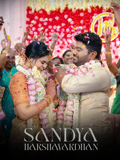 A beautiful, high-energy shot of the couple being showered with petals by their guests.