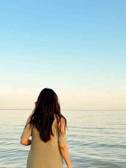 Looking out at the endless horizon, enjoying a peaceful moment at the beach.
