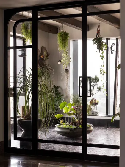These custom arched doors lead to the "Sun Room" in our Bengaluru project. It's a portal to a peaceful, green world we created high up in the sky.