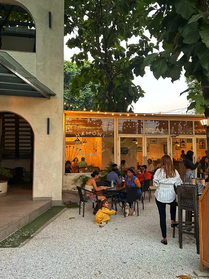 The beautiful architecture of our cafe building, with guests enjoying the outdoor seating area.