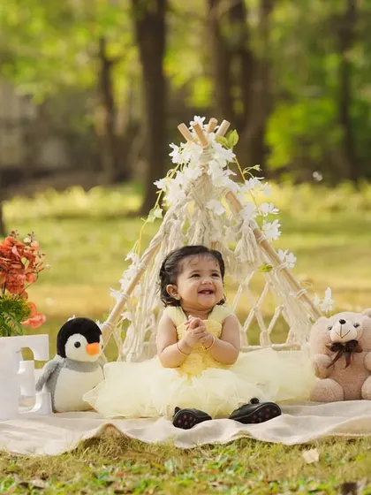 Another adorable outdoor first birthday, this time with a sunny yellow dress and a penguin friend joining the picnic party.