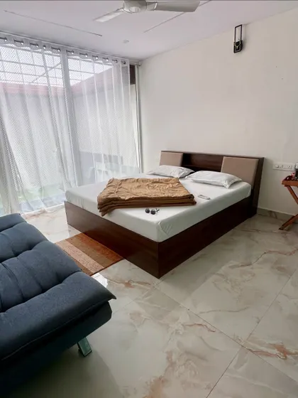 The interior of one of our private pool rooms at Nandi Hills. The room is spacious, with a comfortable bed and direct access to your personal pool.