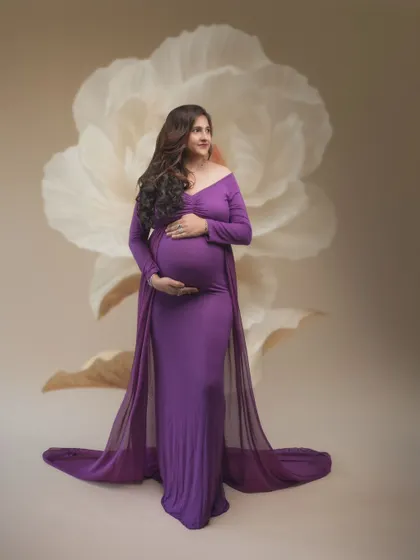 A moment of pure maternity magic. Our stunning model shines in this gorgeous purple gown, showcasing the beauty of motherhood.