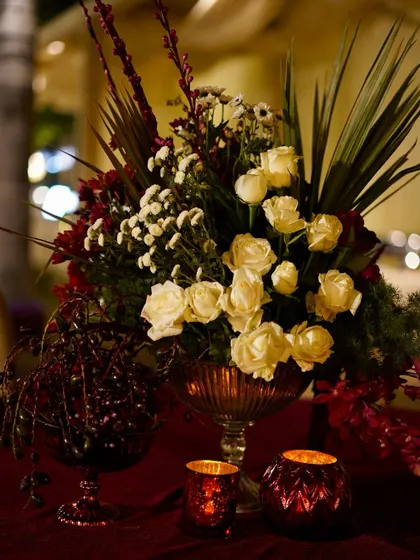 There is something timeless about white roses on a tabletop. Paired with deep red accents, they create a look that is always classy and elegant.