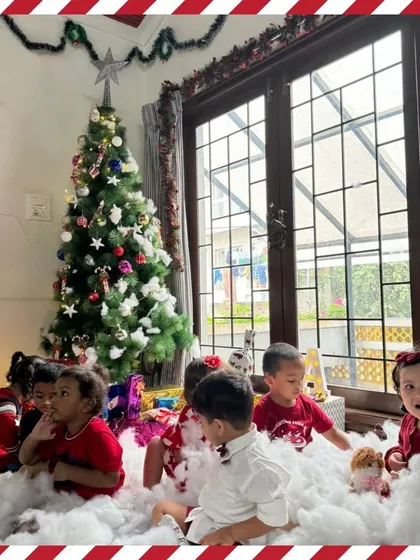 A group of toddlers enjoying the Christmas setup.