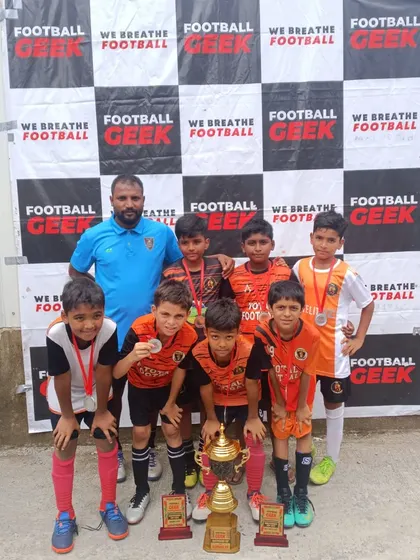 Our U11 team celebrating their championship win at the Independence Cup.