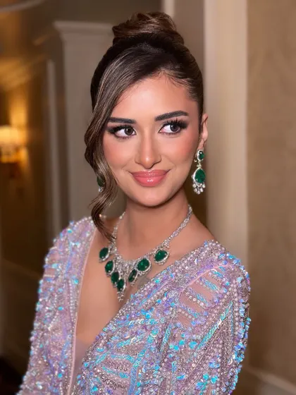 A smiling portrait that captures the joy and confidence this makeup look brings. The glossy lip and sparkling eyes are the perfect finishing touches.