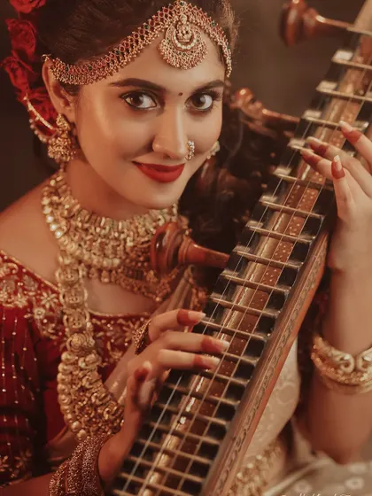 A festive Deepavali-themed shoot with an actress and a veena. The warm, candle-lit setting and rich traditional attire create a celebratory and artistic atmosphere.