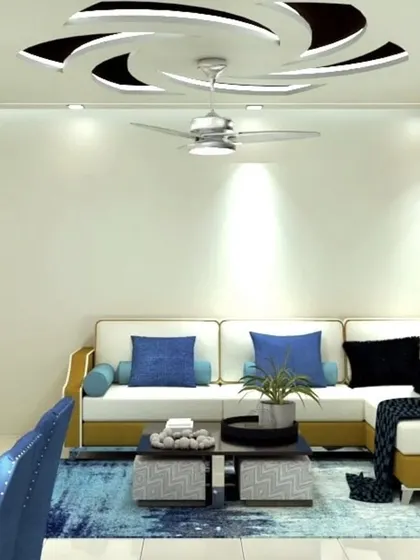 The L-shaped sofa in mustard and white is the centerpiece of this living room. Above, a dynamic spiral false ceiling design adds a unique architectural element to the space.