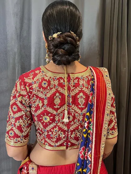 A close-up of the intricate braiding within the classic bun. The small gold accessory adds just the right amount of detail.