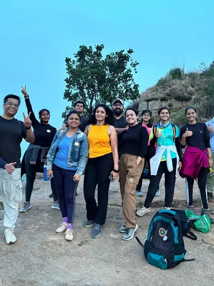 A team enjoying the view from the top of Skandgiri. The sense of accomplishment and the stunning vistas are a powerful combination for team morale.