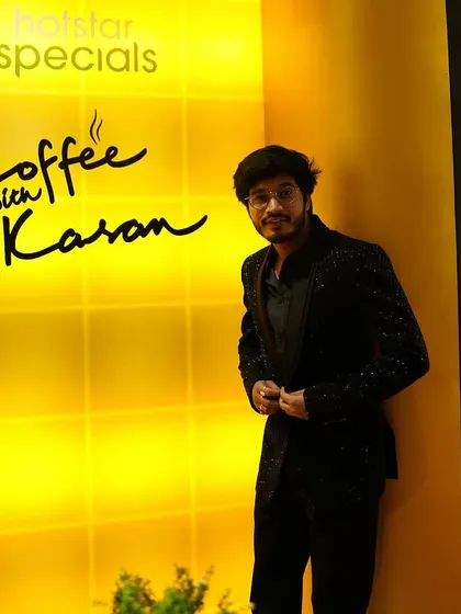 Another shot of RJ Raghav in his custom Dawood Khan jacket. The fit and fabric were chosen to create a sharp silhouette against the bright, iconic background of the show's set.