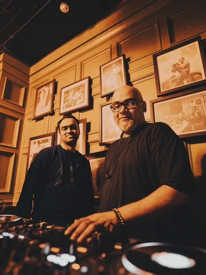 A candid shot of the DJs between sets. It's all smiles and good vibes.