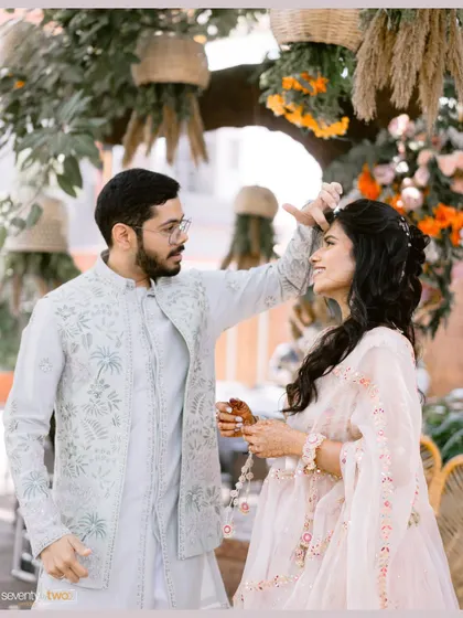 A playful, candid moment between the couple during their Haldi ceremony, their easy chemistry shining through.