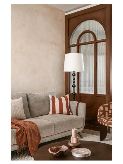 A similar shot of the living room seating, emphasizing the warm and inviting color palette. The design proves that you can mix patterns and textures effectively when you stick to a cohesive color story.