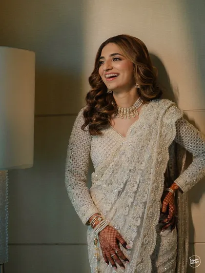 A joyful, candid shot of the bride laughing, capturing her natural beauty and happiness.