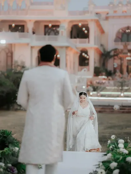 The bride's hopeful steps towards her future. This over-the-shoulder perspective creates a powerful narrative of anticipation and the beginning of a new chapter at a stunning palace venue.