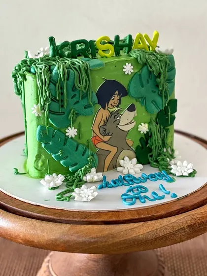 A side view of the vibrant green Jungle Book themed cake.