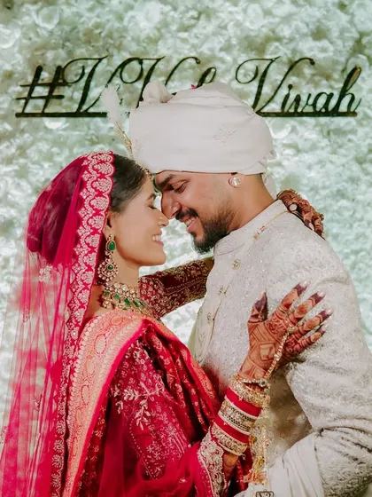 A sweet, intimate moment against their wedding hashtag. This photo is all about their connection, shutting out the world for a second to just be with each other.