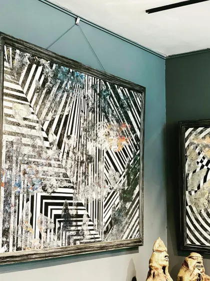 For the love of geometry and horses. This large monochrome painting, with its intersecting lines and abstract patterns, hangs in a gallery, showcasing my exploration of form and contrast.