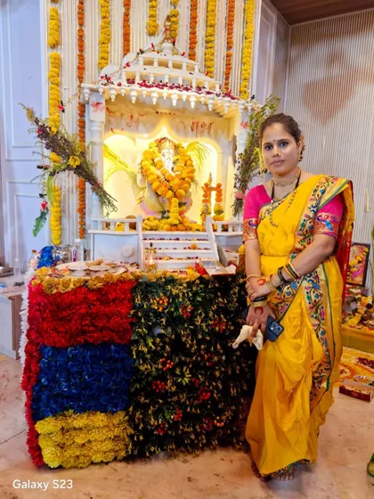 A client celebrating Ganpati festival in a traditional yellow saree from my collection.