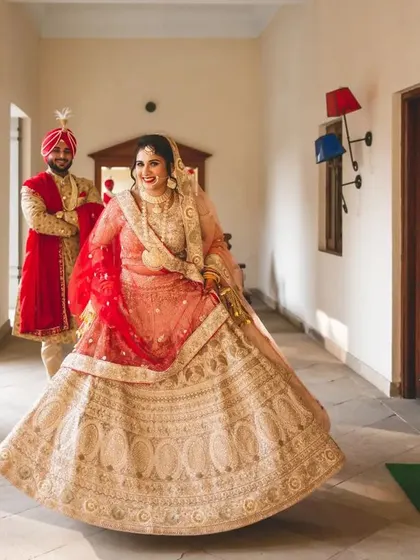 A joyful twirl from the bride as her groom looks on. This captures the beautiful movement of her lehenga and her happiness.