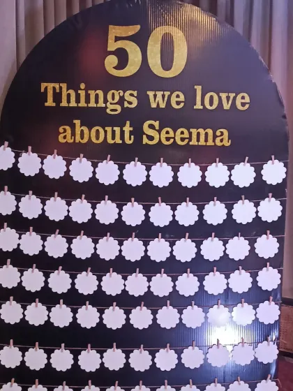 A creative and interactive element for a 50th birthday: a board for guests to write "50 things we love about Seema". It's a wonderful personal touch.