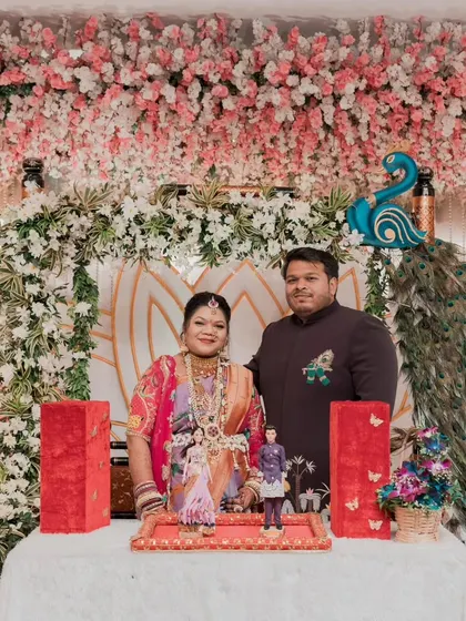 Kajal and her husband at their baby shower, holding the custom-made dolls we created to look just like them. It's a perfect, personal touch for any celebration.