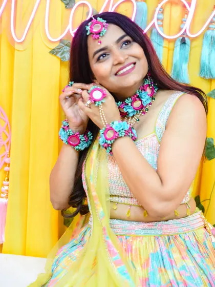 A joyful, upward glance from the bride-to-be, capturing her excitement during the Mehendi celebration.
