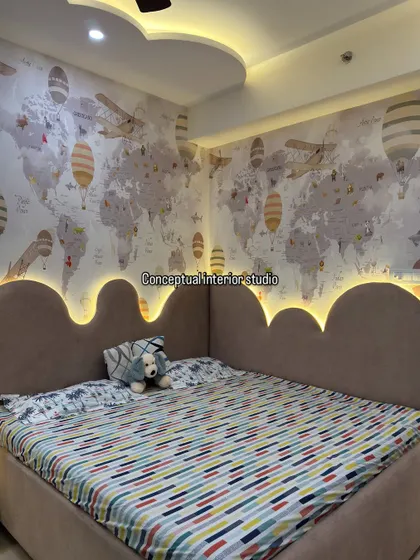 The cloud-shaped headboard with integrated backlighting creates a dreamy and magical ambiance in this child's bedroom.