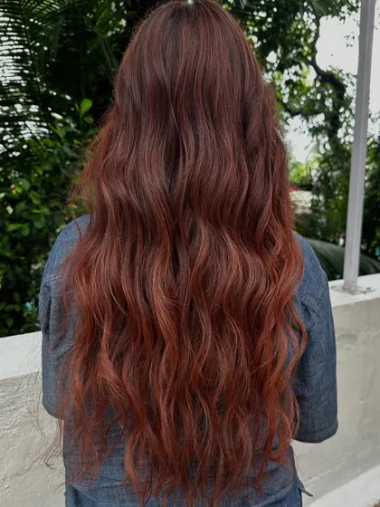 The back view of her red-tinted holiday hair.
