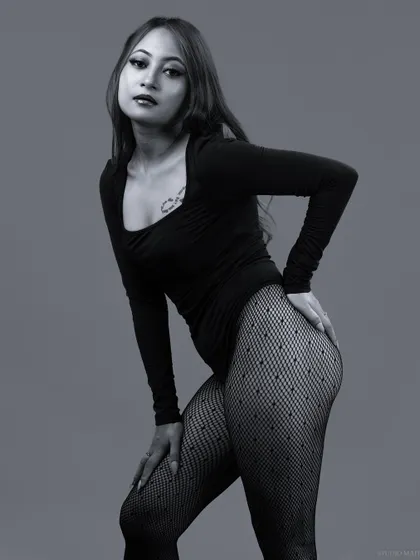 A strong, confident pose in black and white, highlighting the model's form.