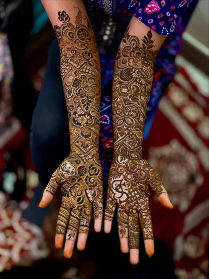 Another angle of this intricate bridal henna, showcasing the symmetry and balance in the design. The dark paste promises a rich and long lasting stain.