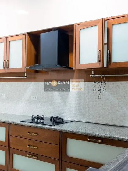 Another view of the classic wooden kitchen, showcasing the frosted glass cabinet doors and ample counter space. This design is perfect for those who appreciate traditional aesthetics.
