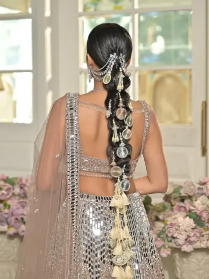 This shot provides a clear and direct view of the full braid, showing the symmetry and craftsmanship involved in creating such a detailed look for a jewellery campaign.