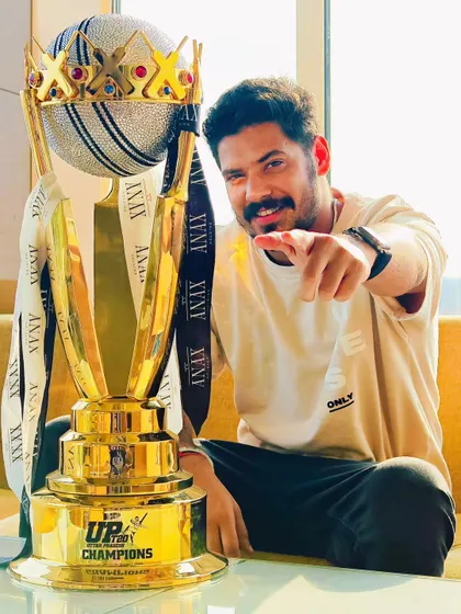A more casual, off-field portrait with the championship trophy. These relaxed shots add a personal touch to the victory narrative.