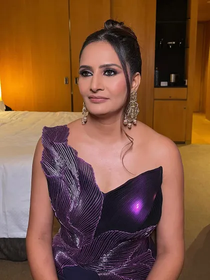 A confident and glamorous look for a milestone celebration. The bold eye makeup is the star, balanced with a neutral lip and perfectly sculpted features.