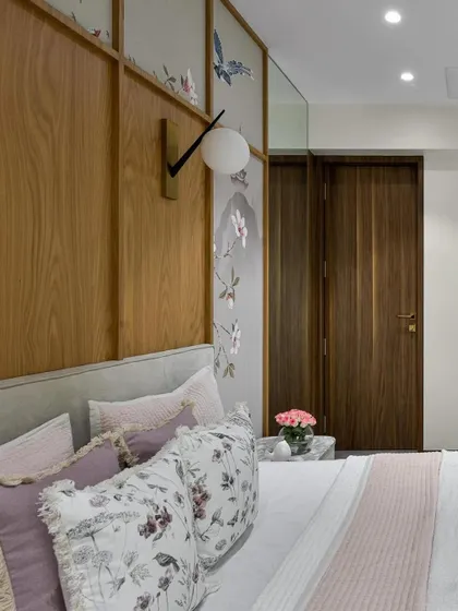 The delicate details of the Chinoiserie wallpaper and plush floral cushions create a harmonious and luxurious bedroom retreat. The soft color palette and nature-inspired motifs work together to foster a relaxing ambiance.