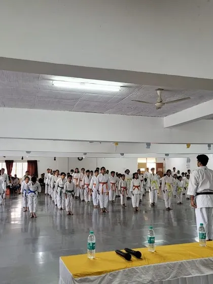 Students line up with discipline at the start of their belt exam, demonstrating the respect and order that is fundamental to dojo life.