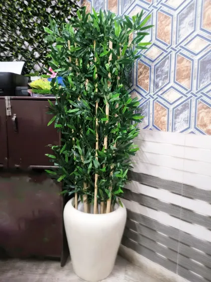 Artificial plants like this tall bamboo in a ceramic planter are a great way to add greenery to a corner with zero maintenance.