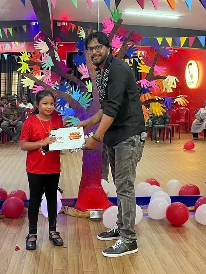 This young dancer proudly holds her certificate after the showcase. It's a great confidence booster for the kids.