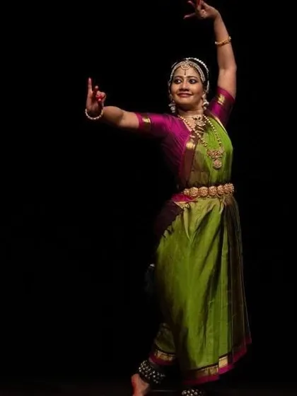 A student in a graceful pose, her costume adding to the visual beauty of the performance.