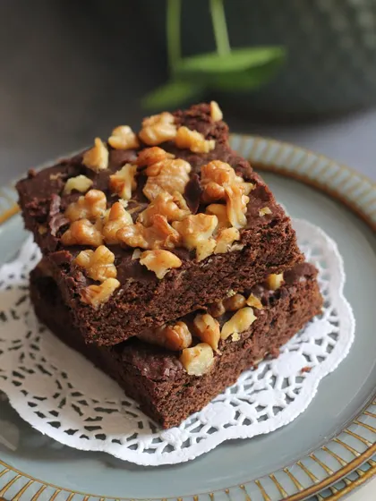 A stack of classic walnut brownies, a timeless favorite that's always in demand.
