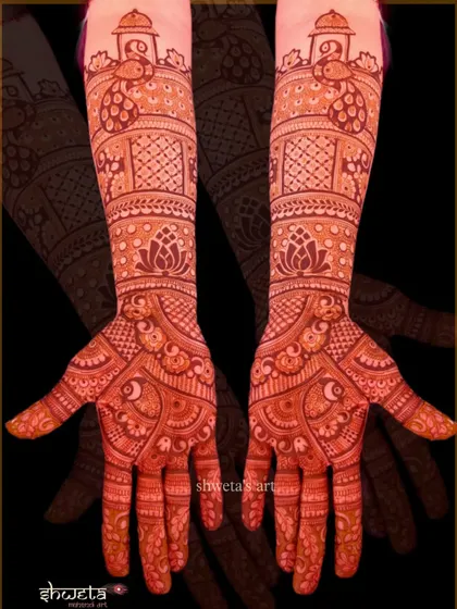 This design features stunning peacock motifs at the top of the arm, with intricate patterns flowing down to the palms. The rich red stain shows the quality of my natural henna.