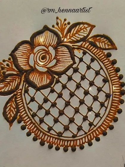 This is a demonstration of a mandala design that incorporates a net or grid pattern, known as a 'jaali'. The design is framed with a beautiful rose and leaves, combining geometric and floral elements.