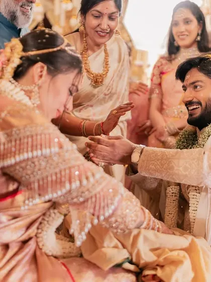 A joyful, candid moment between the couple during their wedding ceremony, surrounded by smiling family members.