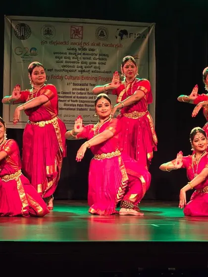 Our group presenting a traditional piece at the Friday Cultural Programme. The matching red costumes and synchronized poses create a powerful visual impact on stage.