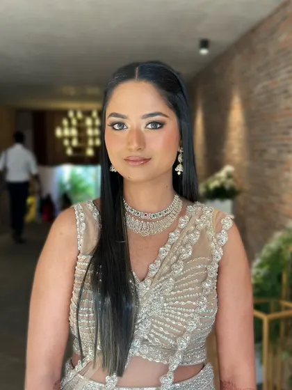 A direct, confident portrait. The makeup is polished and elegant, with a focus on defined eyes and a perfect, radiant base.