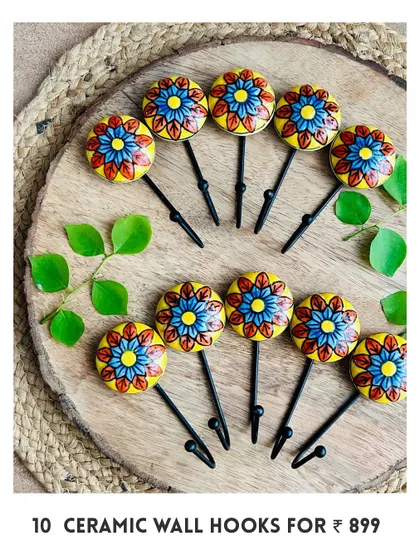 Another design of our new mini ceramic wall hooks. This set of 10 features a beautiful yellow and blue floral pattern, hand-painted by local artisans to add a unique touch to your walls.